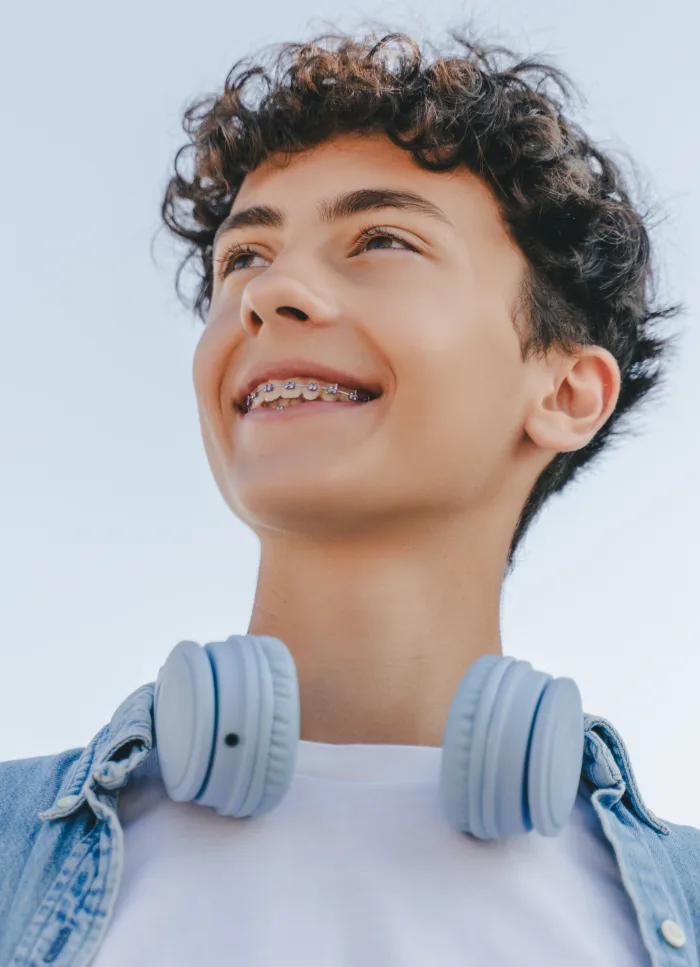 A teenager smiling with braces