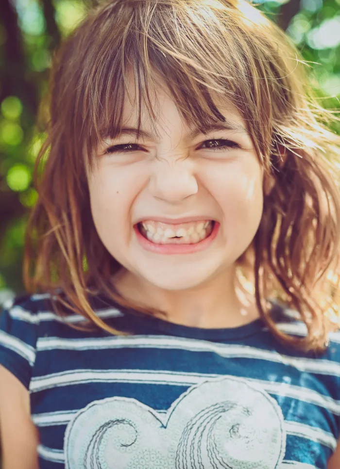 A young child with a happy gap-toothed smile