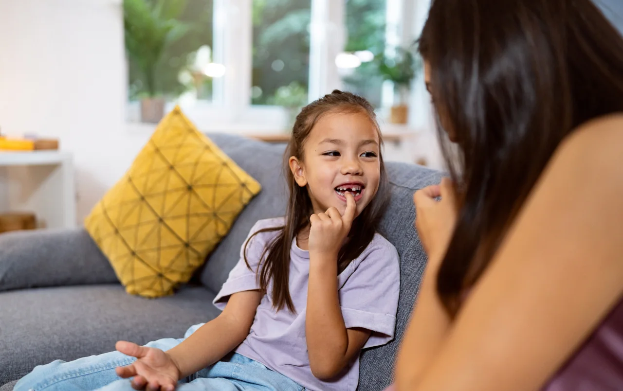 A young girl chatting with her mum about orthodontic treatment