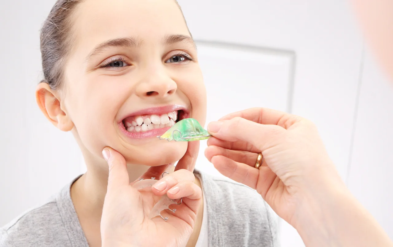 A child trying on an orthodontic appliance
