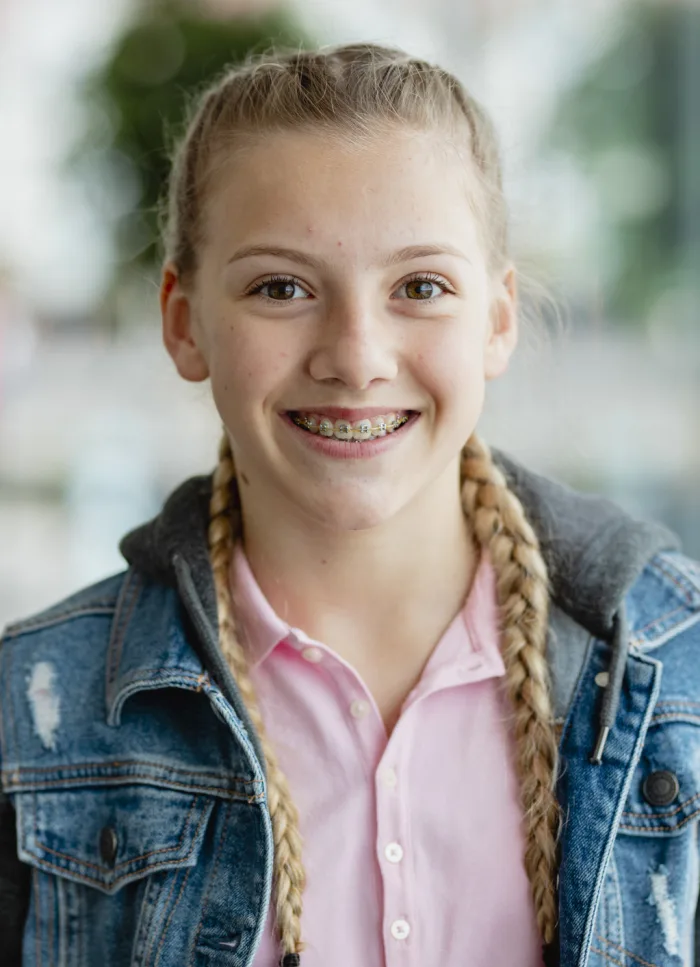 A teenager smiling with braces
